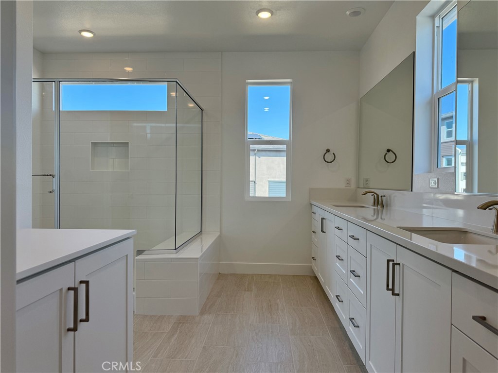 109 Trask Irvine, CA 92618 - Photo 11 of 25 a bathroom with a granite countertop sink a toilet and mirror