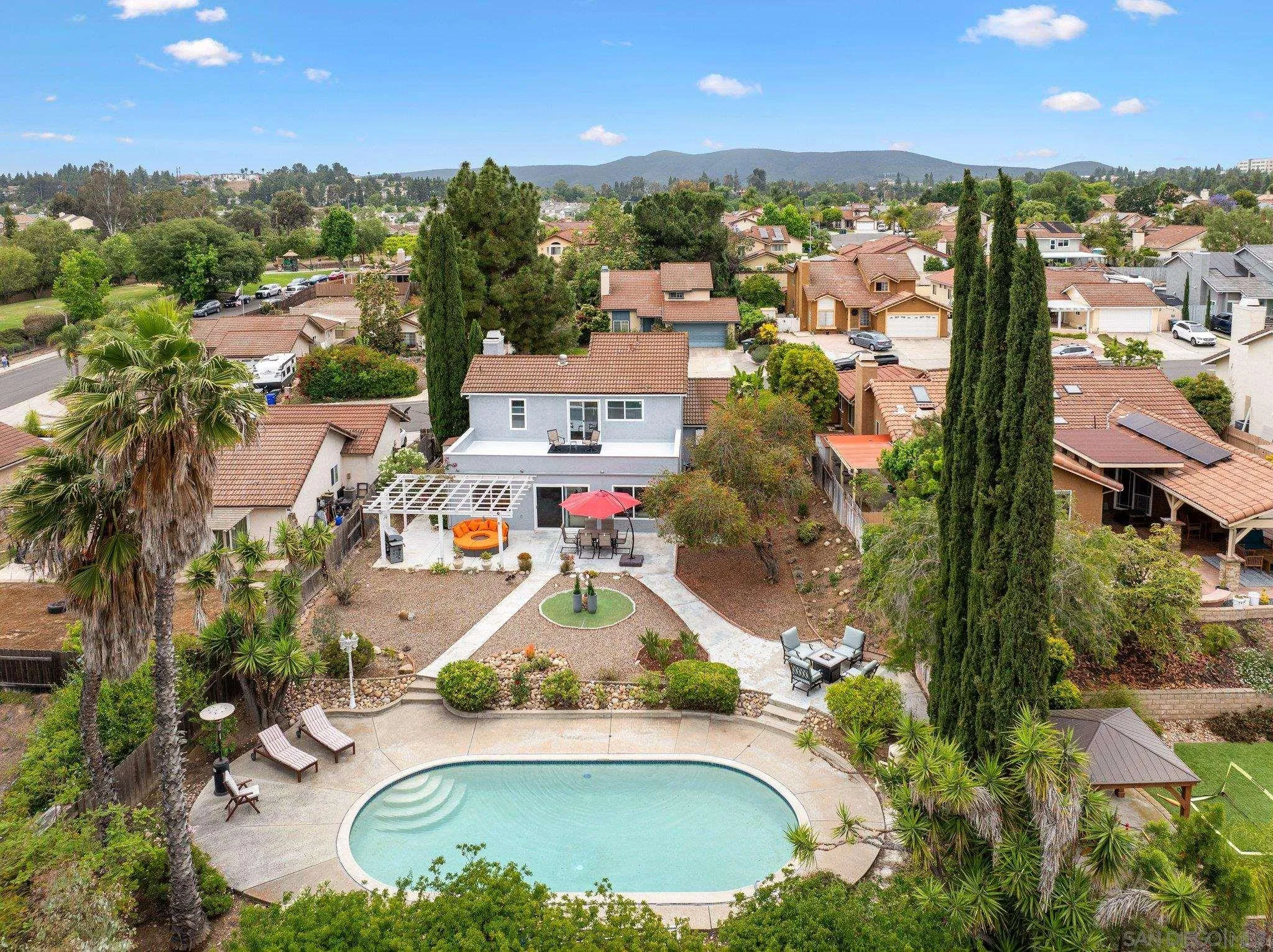 an aerial view of residential houses with outdoor space and parking