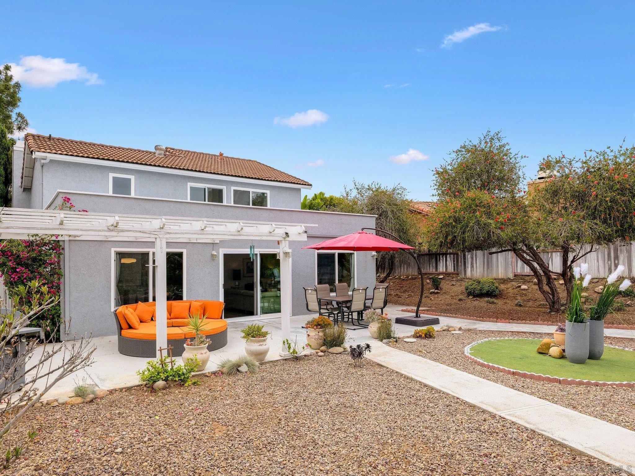 14813 Morningside Drive Poway, CA 92064 - Photo 18 of 37 a view of a white house with swimming pool lawn chairs and a fire pit