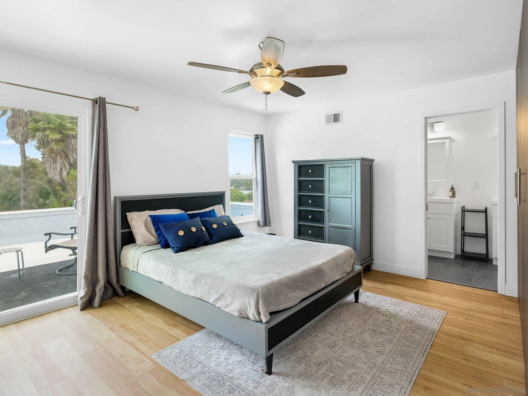 14813 Morningside Drive Poway, CA 92064 - Photo 25 of 37 a bedroom with a large bed and a chandelier