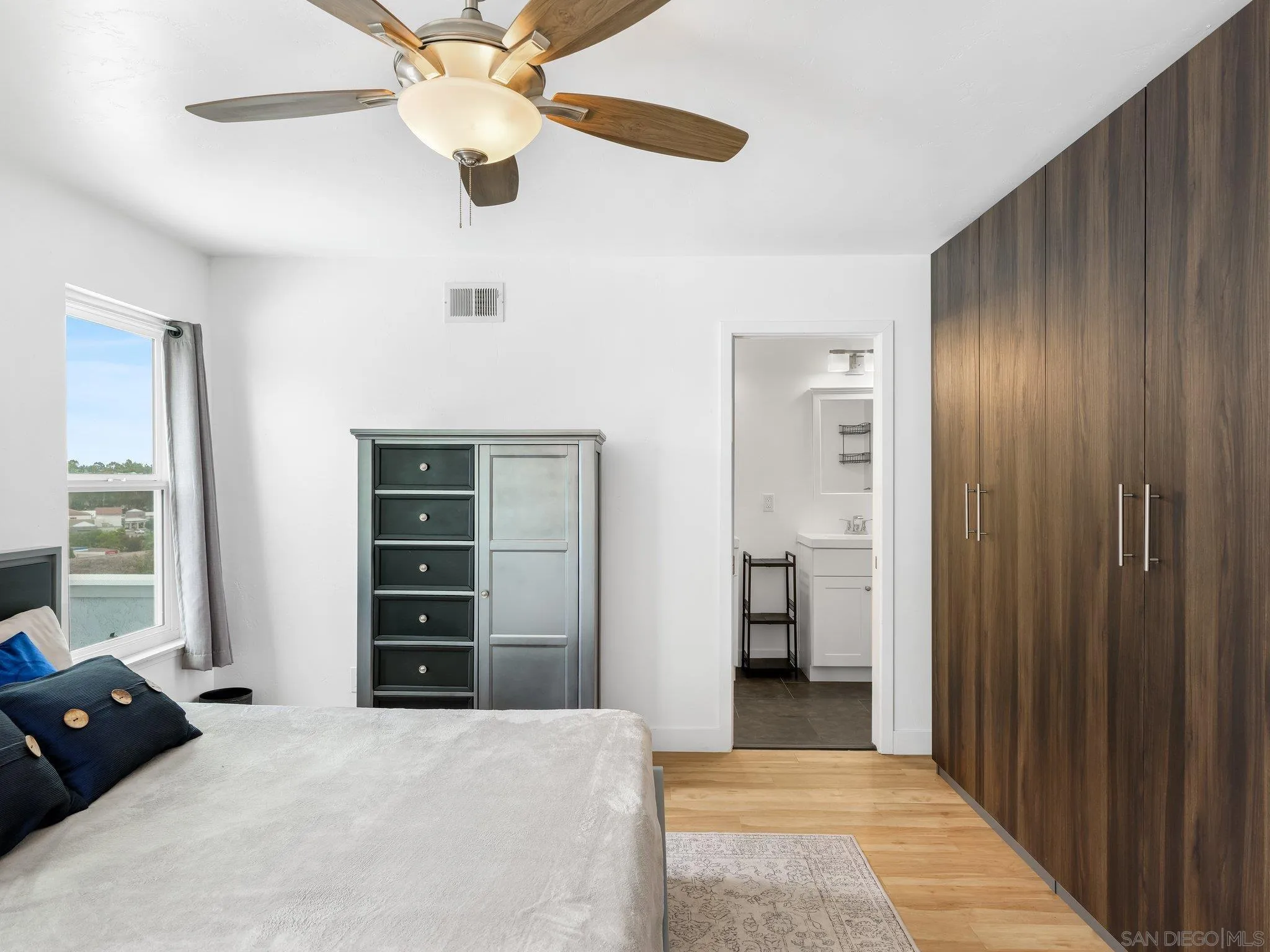 14813 Morningside Drive Poway, CA 92064 - Photo 26 of 37 a bedroom with a bed and a chandelier fan