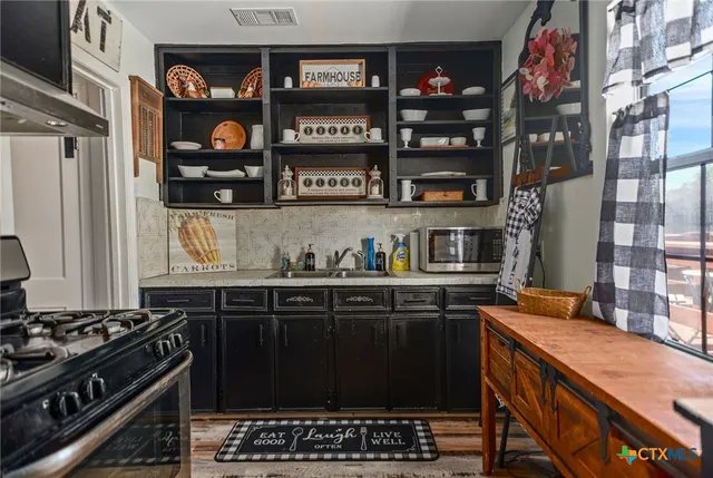 a kitchen with stainless steel appliances granite countertop a stove and a sink