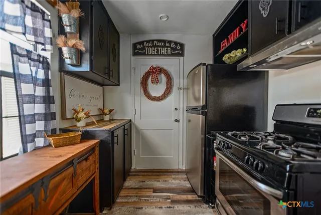 a kitchen with stainless steel appliances granite countertop a stove and a sink