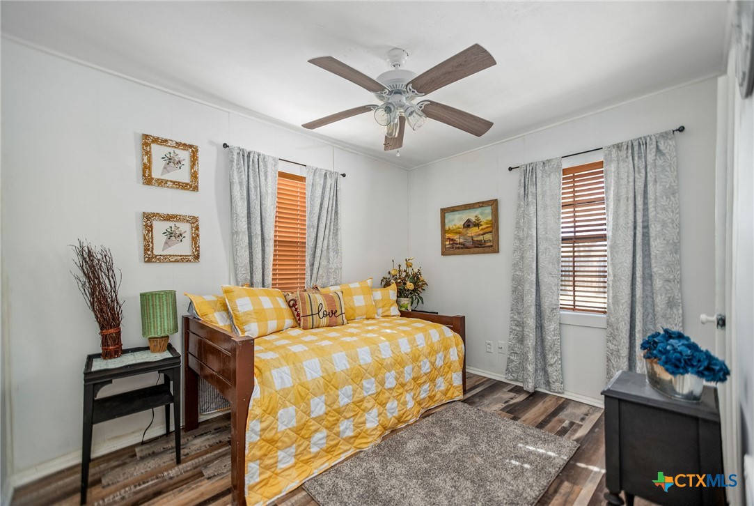 101 Lubbock Street Point Comfort, TX 77979 - Photo 22 of 34 a bedroom with a bed and wooden floor
