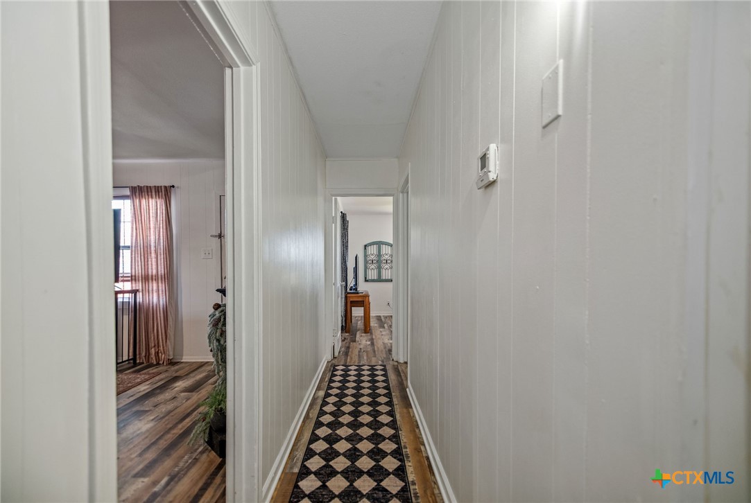 101 Lubbock Street Point Comfort, TX 77979 - Photo 24 of 34 a view of a hallway with wooden floor and staircase