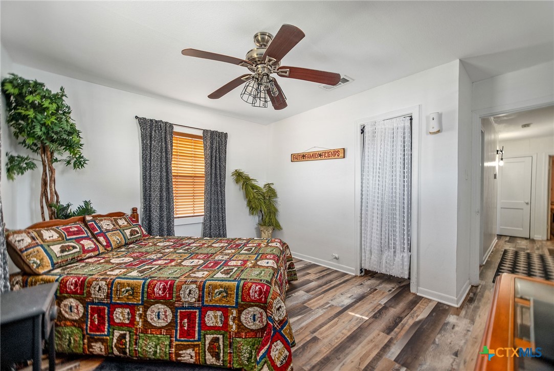 101 Lubbock Street Point Comfort, TX 77979 - Photo 28 of 34 a bedroom with a bed a dresser and potted plants