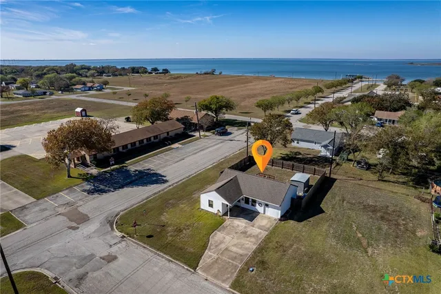 an aerial view of a house with lake view