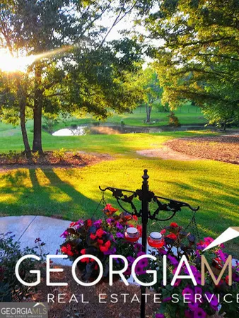 a front view of a house with a yard and a garage