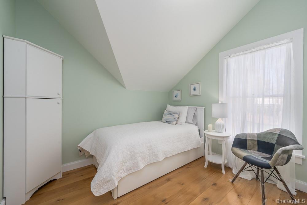 19000 Main Road Mattituck, NY 11952 - Photo 24 of 32 Bedroom featuring vaulted ceiling, wood finished floors, and baseboards