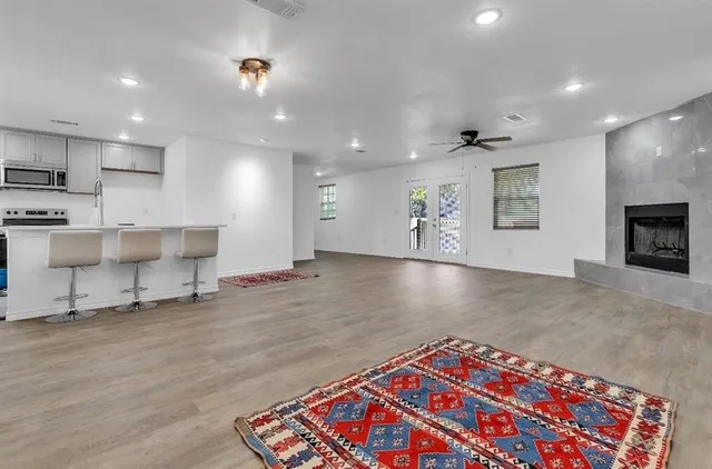 a large hall with a rug and a fireplace