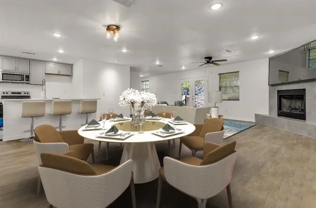 a dining room with furniture and a kitchen view