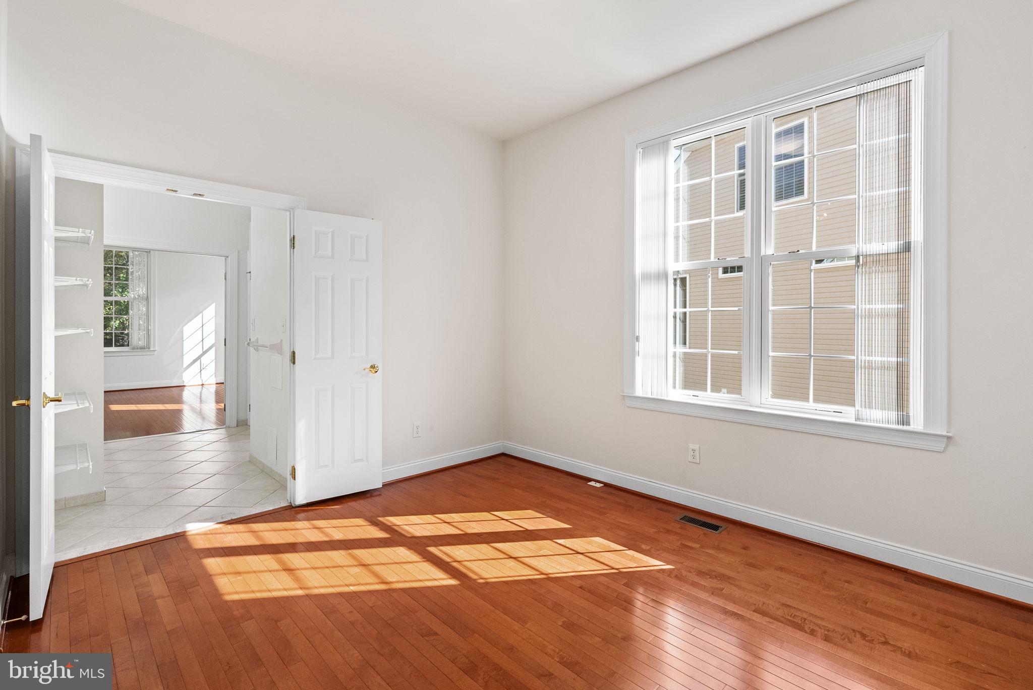 133 Sloan Road Phoenixville, PA 19460 - Photo 19 of 67 an empty room with wooden floor and windows