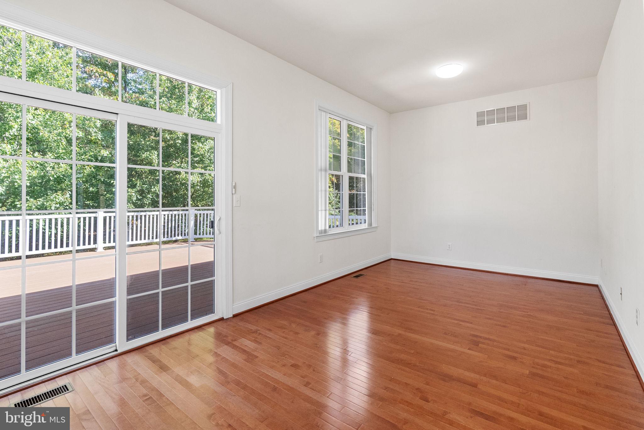 133 Sloan Road Phoenixville, PA 19460 - Photo 27 of 67 a view of an empty room with wooden floor and windows