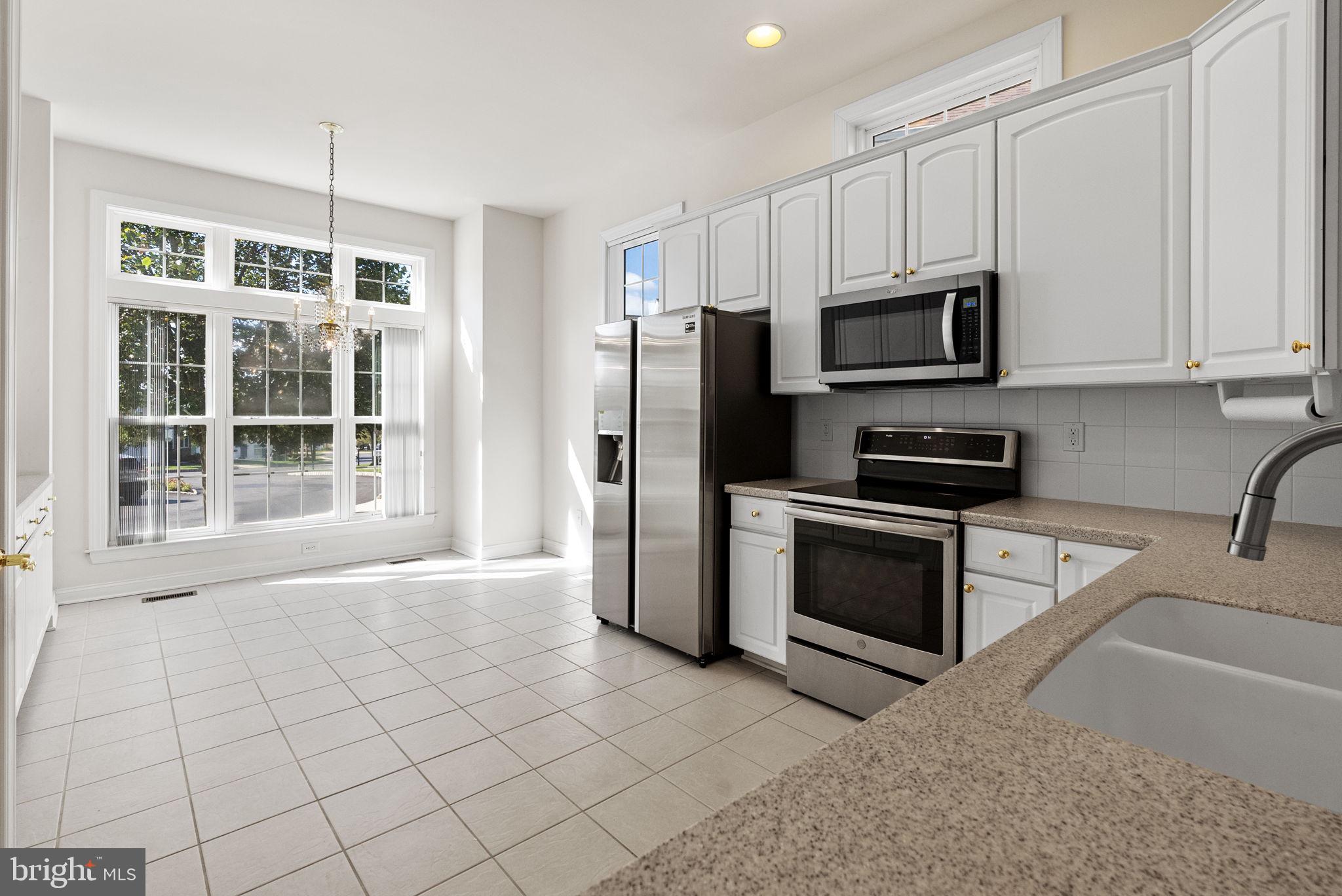 133 Sloan Road Phoenixville, PA 19460 - Photo 7 of 67 a kitchen with stainless steel appliances a stove a microwave and a sink
