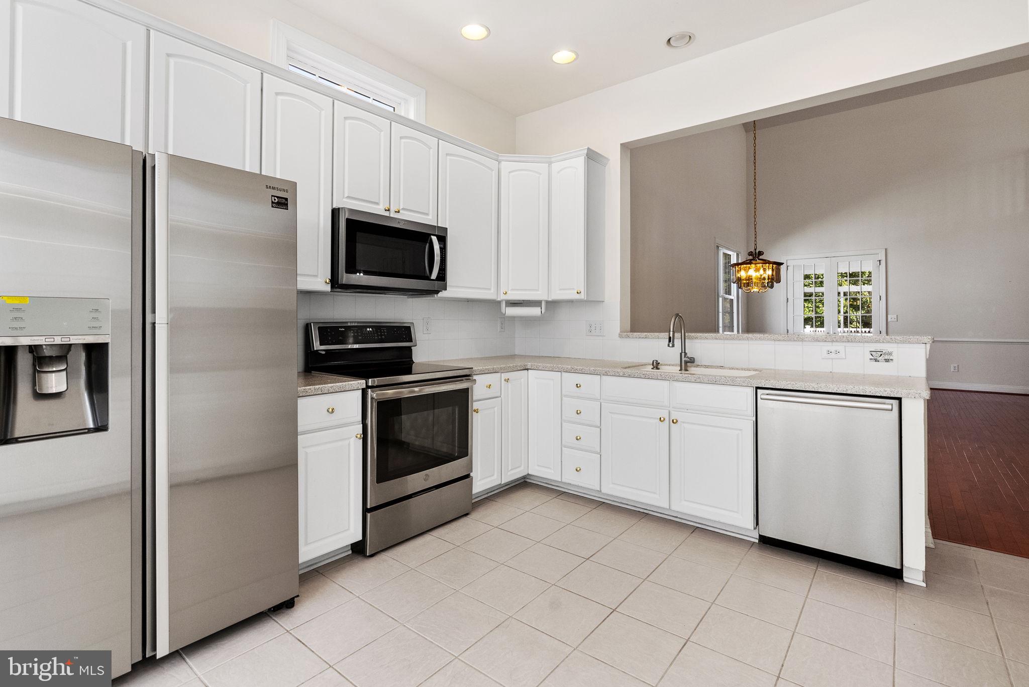 133 Sloan Road Phoenixville, PA 19460 - Photo 9 of 67 a kitchen with white cabinets stainless steel appliances and a sink