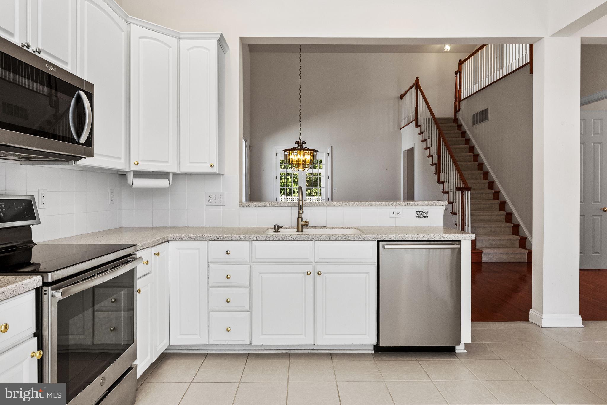 133 Sloan Road Phoenixville, PA 19460 - Photo 10 of 67 a kitchen with white cabinets stainless steel appliances and sink