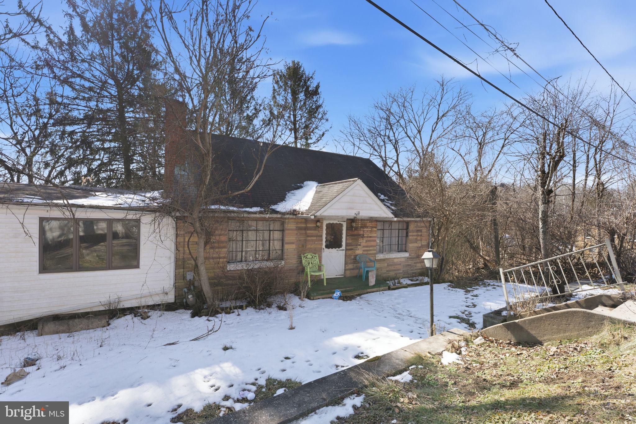 210 Roberts Street Fairmont, WV 26554 - Photo 1 of 15 a view of a house with a yard covered in snow