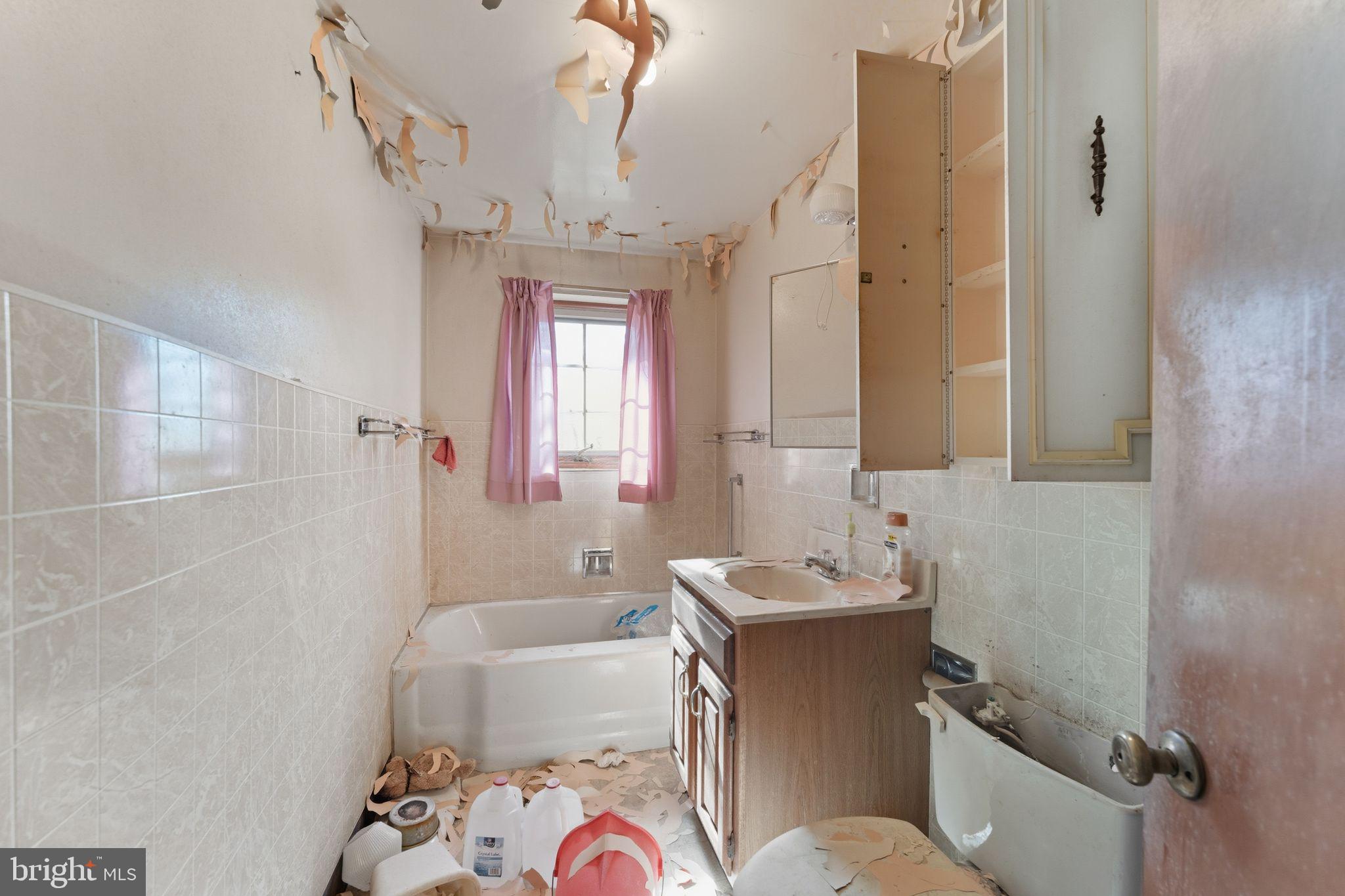 210 Roberts Street Fairmont, WV 26554 - Photo 12 of 15 a bathroom with a sink a toilet a mirror and shower