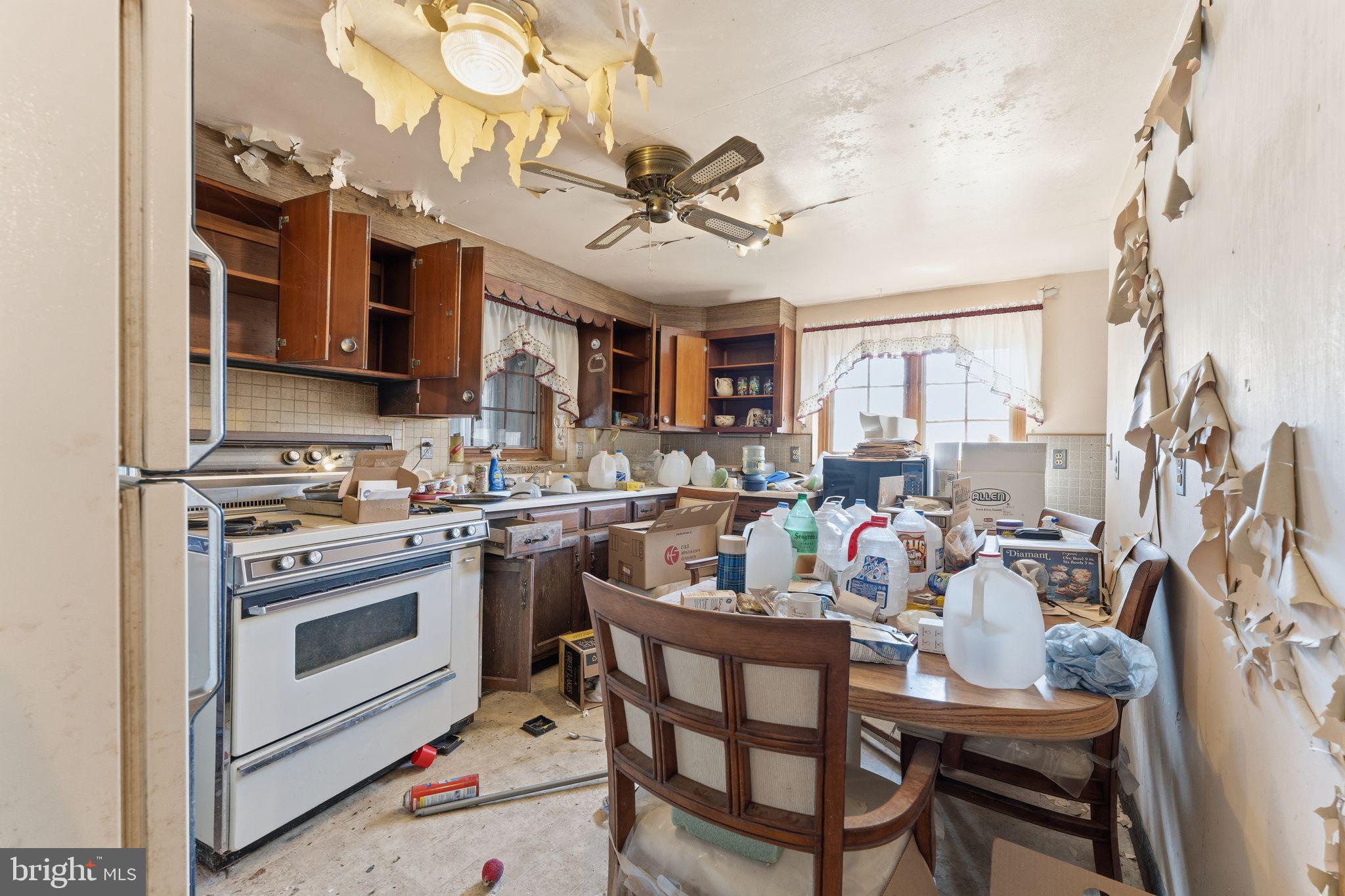 210 Roberts Street Fairmont, WV 26554 - Photo 6 of 15 a kitchen with a stove cabinets and chairs