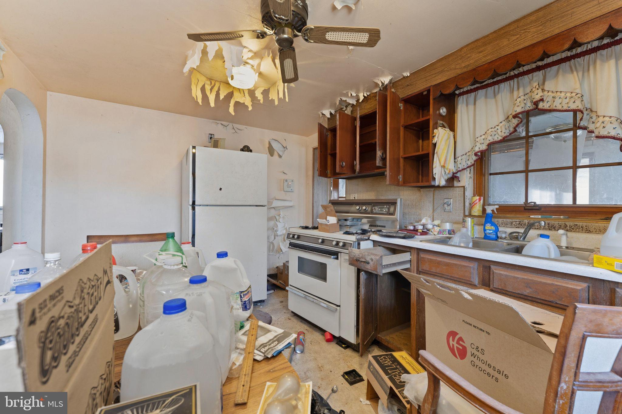 210 Roberts Street Fairmont, WV 26554 - Photo 7 of 15 a kitchen with a white cabinets and white appliances