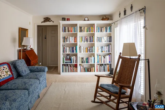 a living room with a couch and a book shelf