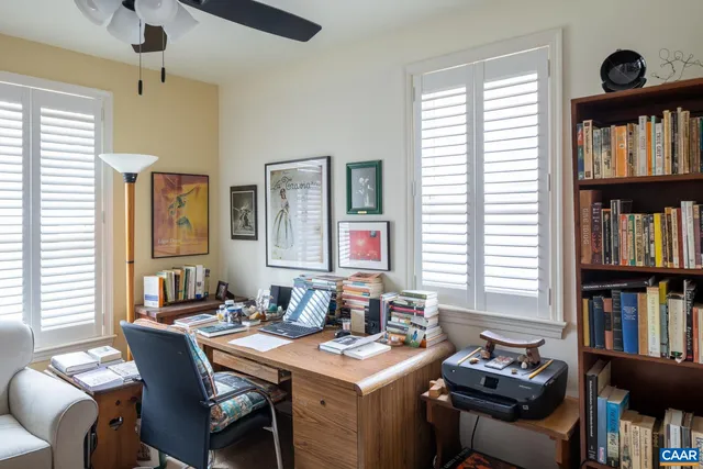 a view of a workspace with furniture and a window