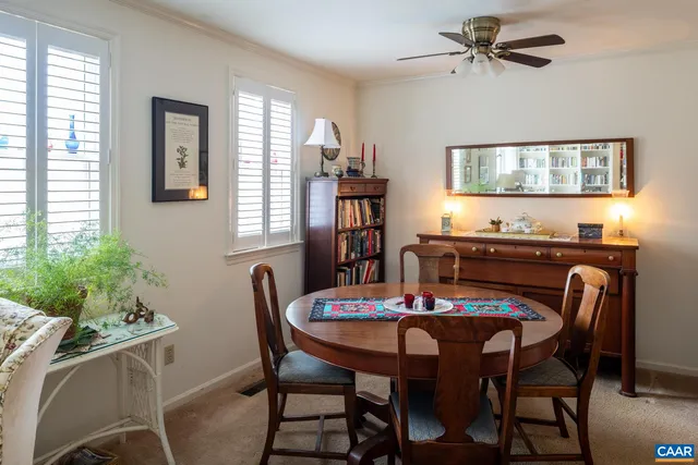 a view of a dining room with furniture and window