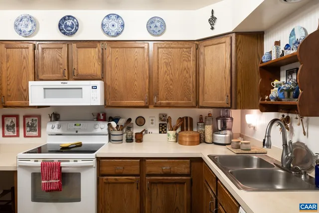 a kitchen with a sink a stove and cabinets