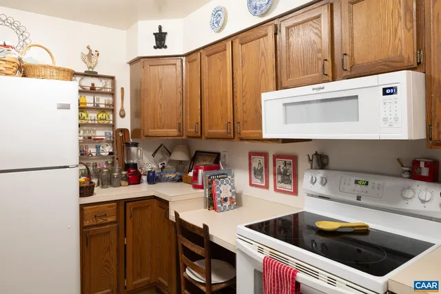a kitchen with stainless steel appliances a stove a sink and cabinets