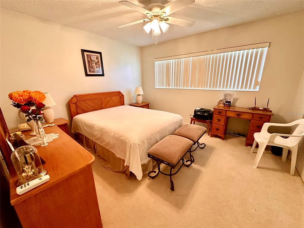 2404 Florentine Way, Unit 2 Clearwater, FL 33763 - Photo 14 of 37 a bedroom with two beds and a chandelier