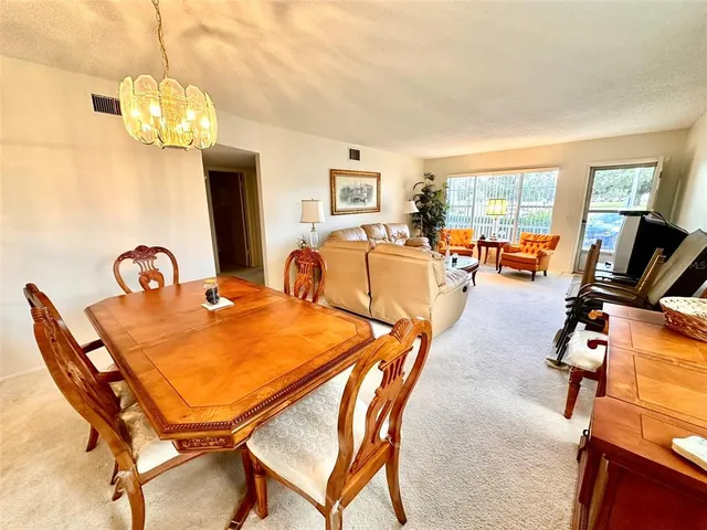 a dining room with furniture and chandelier