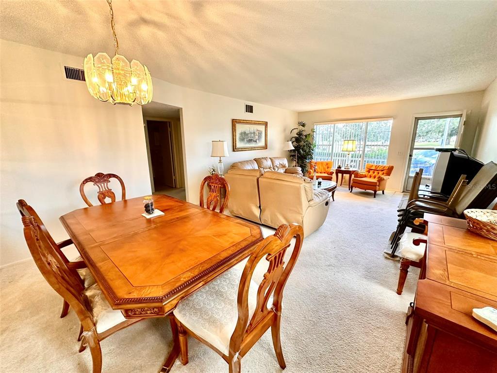 2404 Florentine Way, Unit 2 Clearwater, FL 33763 - Photo 4 of 37 a dining room with furniture and chandelier