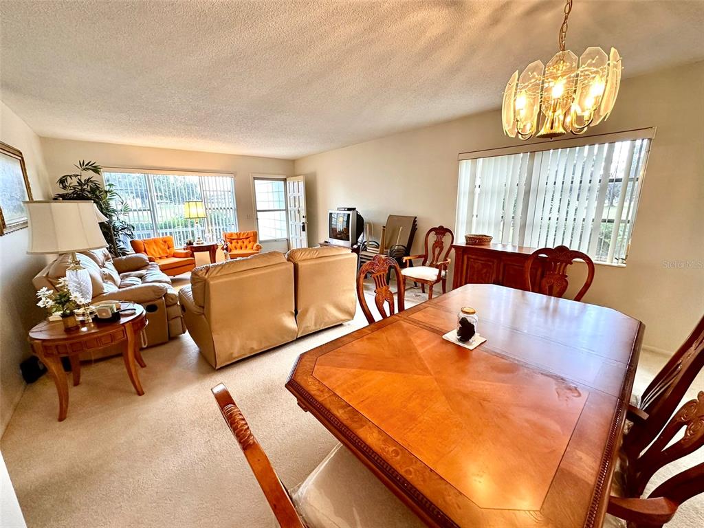 2404 Florentine Way, Unit 2 Clearwater, FL 33763 - Photo 5 of 37 a living room with furniture and a chandelier