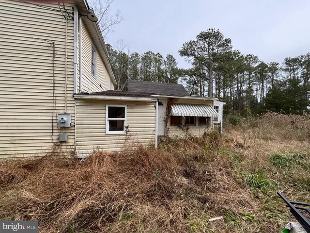 a view of a house with a window and wooden fence