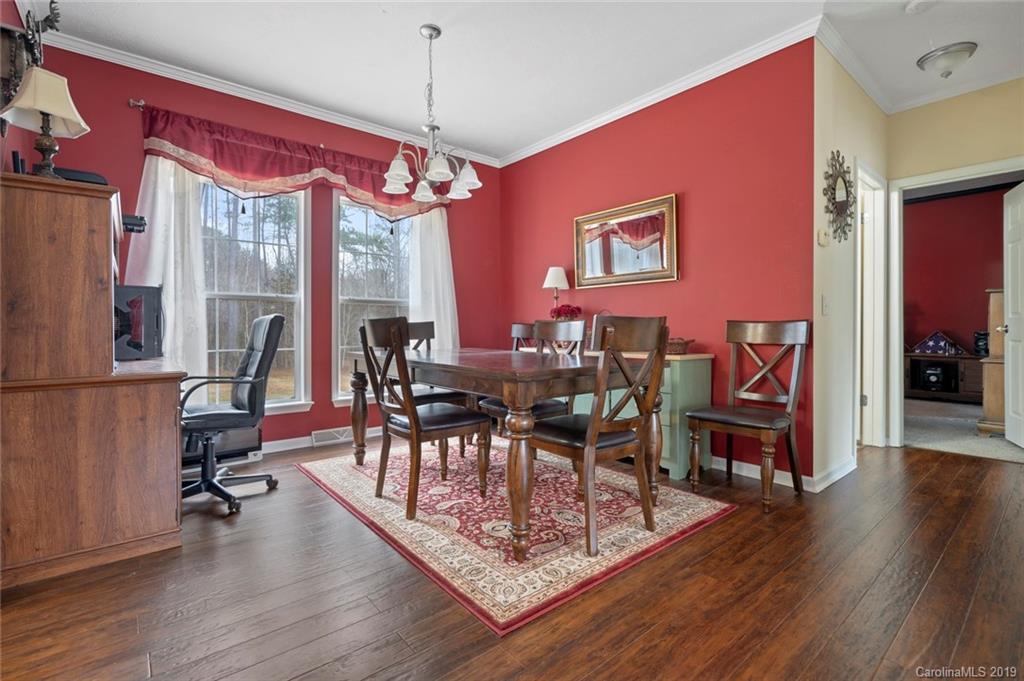 2804 Plyler Mill Road Lancaster, SC 29720 - Photo 13 of 32 a view of a dining room with furniture a chandelier and wooden floor