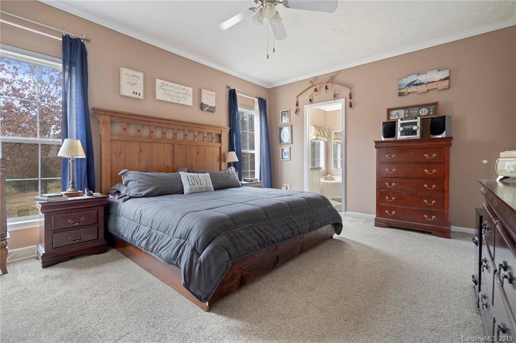 2804 Plyler Mill Road Lancaster, SC 29720 - Photo 18 of 32 a bedroom with a bed and a dresser