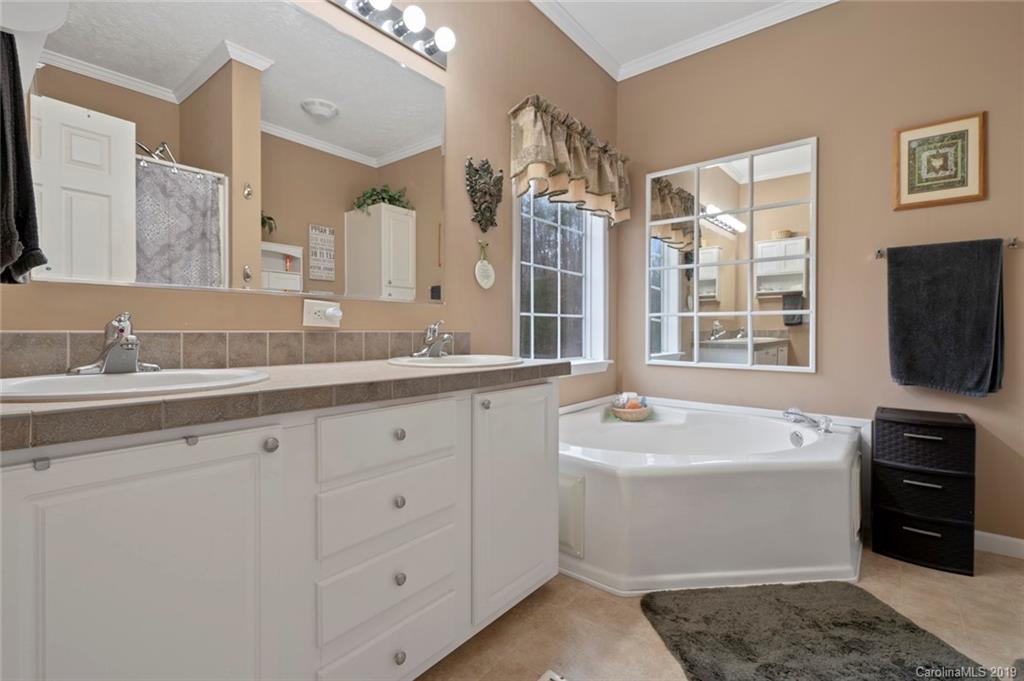 2804 Plyler Mill Road Lancaster, SC 29720 - Photo 21 of 32 a bathroom with a sink double vanity and a mirror