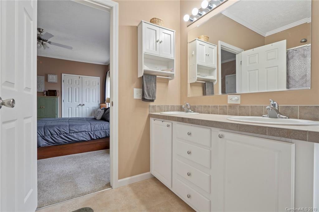 2804 Plyler Mill Road Lancaster, SC 29720 - Photo 23 of 32 a spacious bathroom with a granite countertop sink and a mirror