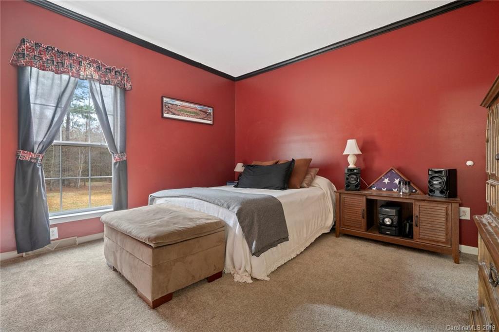 2804 Plyler Mill Road Lancaster, SC 29720 - Photo 25 of 32 a spacious bedroom with a bed and a window
