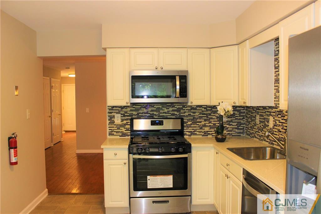 43 Alpine Road Holmdel, NJ 07733 - Photo 12 of 25 a kitchen with a stove and a microwave