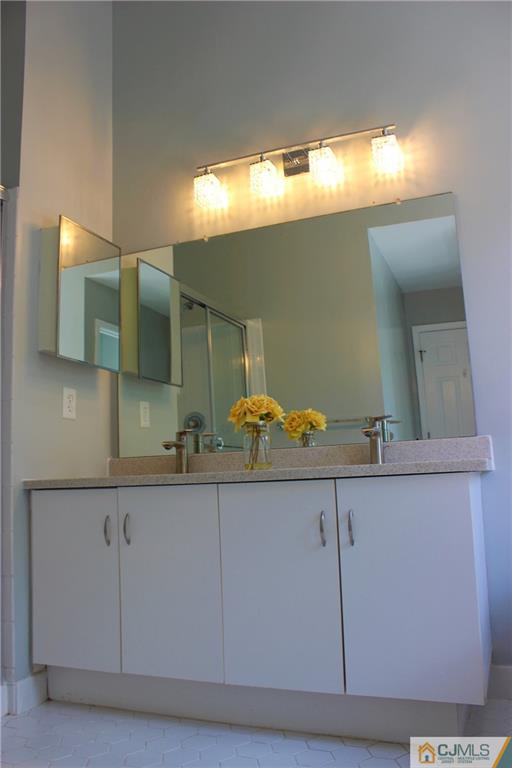 43 Alpine Road Holmdel, NJ 07733 - Photo 17 of 25 a bathroom with a sink and a mirror