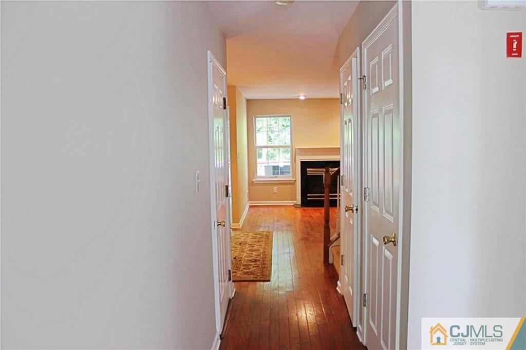43 Alpine Road Holmdel, NJ 07733 - Photo 3 of 25 a view of a hallway with wooden floor and furniture