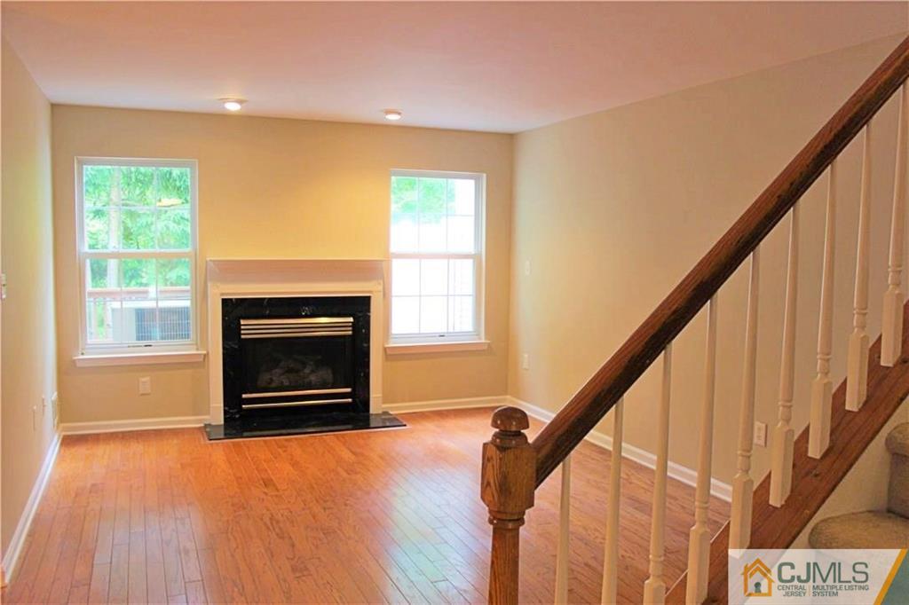 43 Alpine Road Holmdel, NJ 07733 - Photo 4 of 25 a view of an empty room with wooden floor fire place and a window