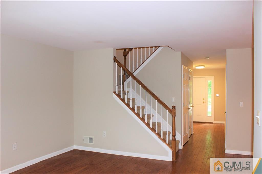 43 Alpine Road Holmdel, NJ 07733 - Photo 6 of 25 a view of staircase with wooden floor and white walls