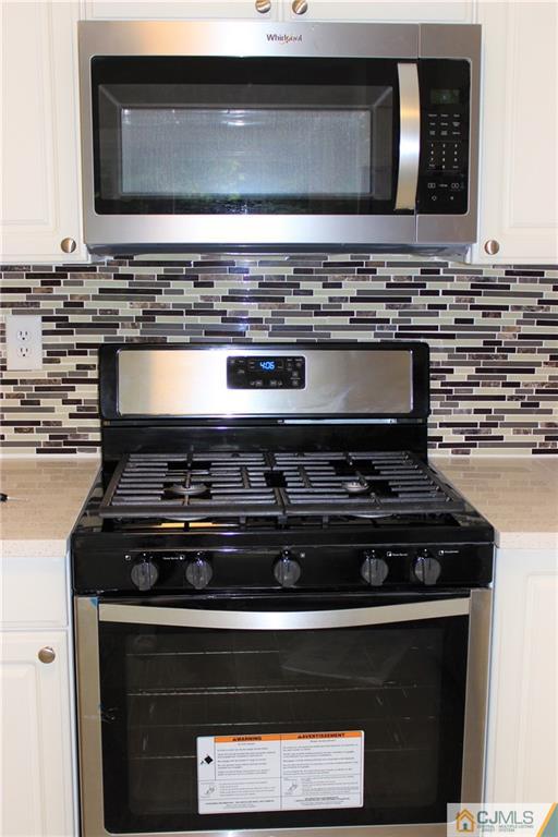 43 Alpine Road Holmdel, NJ 07733 - Photo 10 of 25 a stove top oven sitting inside of a kitchen