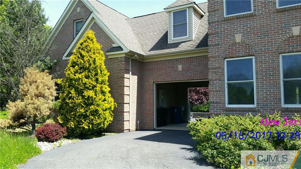134 North Bergen Mills Road Monroe Township, NJ 08831 - Photo 2 of 11 a front view of a house with a yard and flowers