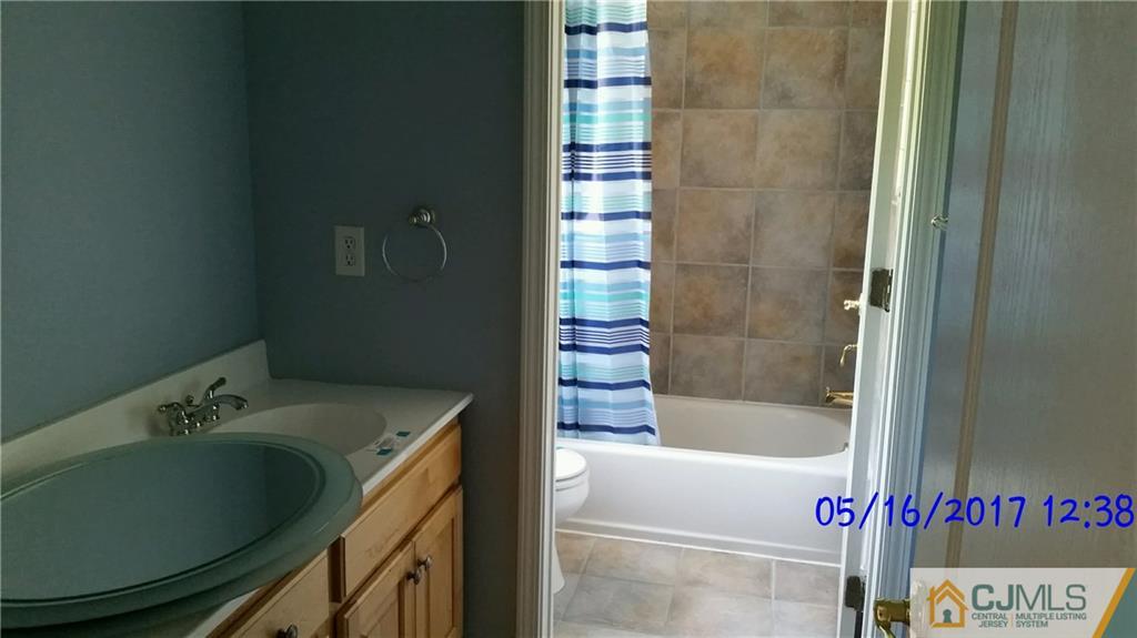 134 North Bergen Mills Road Monroe Township, NJ 08831 - Photo 11 of 11 a bathroom with a tub and shower