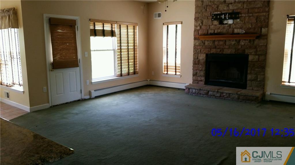 134 North Bergen Mills Road Monroe Township, NJ 08831 - Photo 5 of 11 a view of an empty room with exposed radiator and fireplace