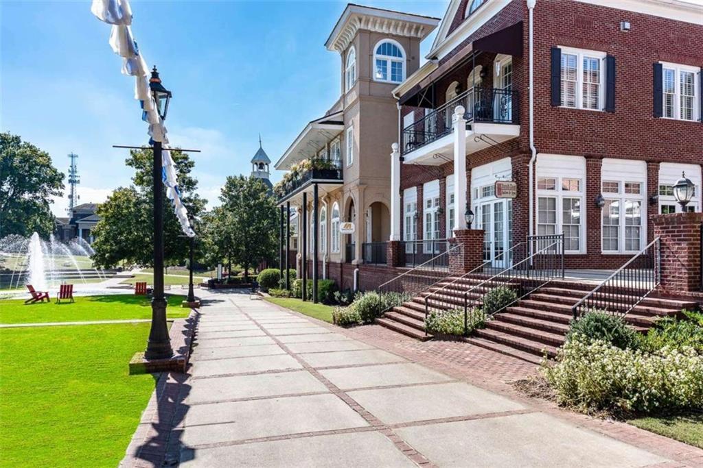 4025 Ivy Run Circle Duluth, GA 30096 - Photo 23 of 34 a front view of a building with garden and trees