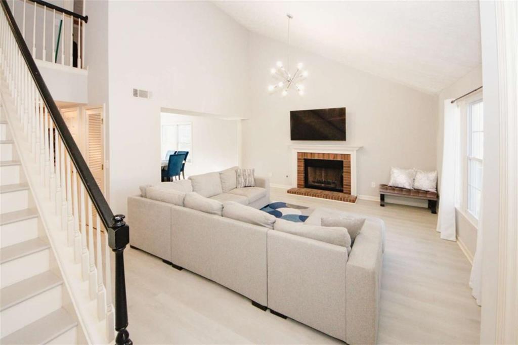 4025 Ivy Run Circle Duluth, GA 30096 - Photo 3 of 34 a living room with furniture and a flat screen tv